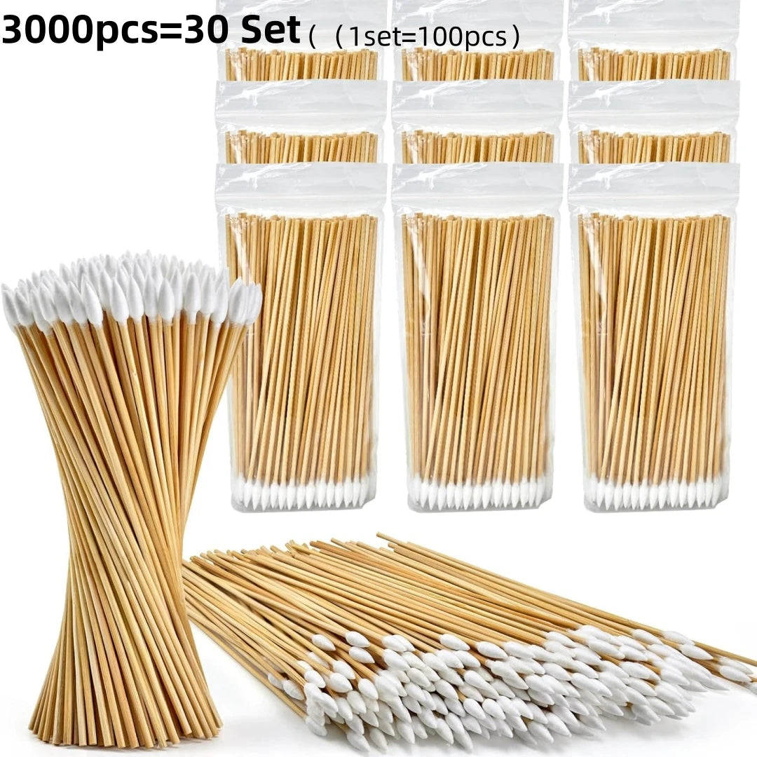 A collection of wooden cotton swabs and white cotton tips are displayed in various arrangements.