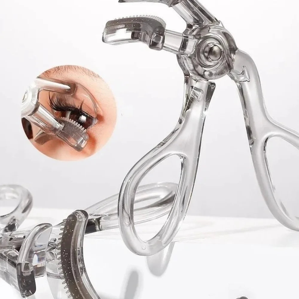 Clear plastic dual-type eyelash curler with comb shown against a white background.