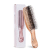 A pink Japanese-style scalp massage brush comb for hair styling and relaxation is shown next to its packaging box.