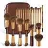A brown makeup brush set with a gold handle is displayed next to its travel case.