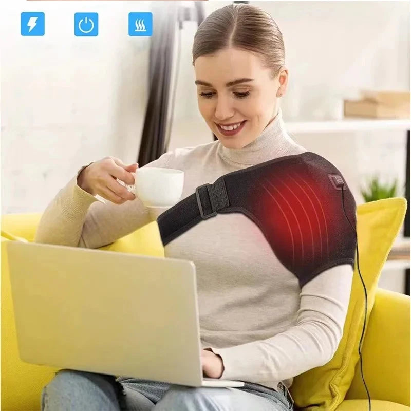 A woman is using a red heated shoulder massage belt while working on a laptop.