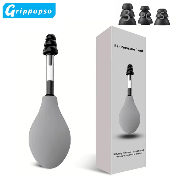 A black ear pressure tool is shown next to its packaging, demonstrating the device's design.