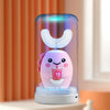 A pink U-shaped sonic electric toothbrush for kids is displayed in a clear cylindrical holder with blue light.
