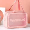 A pink transparent cosmetic storage bag with pink straps and the word WASHBAG printed on it.