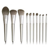 A set of ten professional makeup brushes with silver handles and natural hair bristles displayed on a white background.