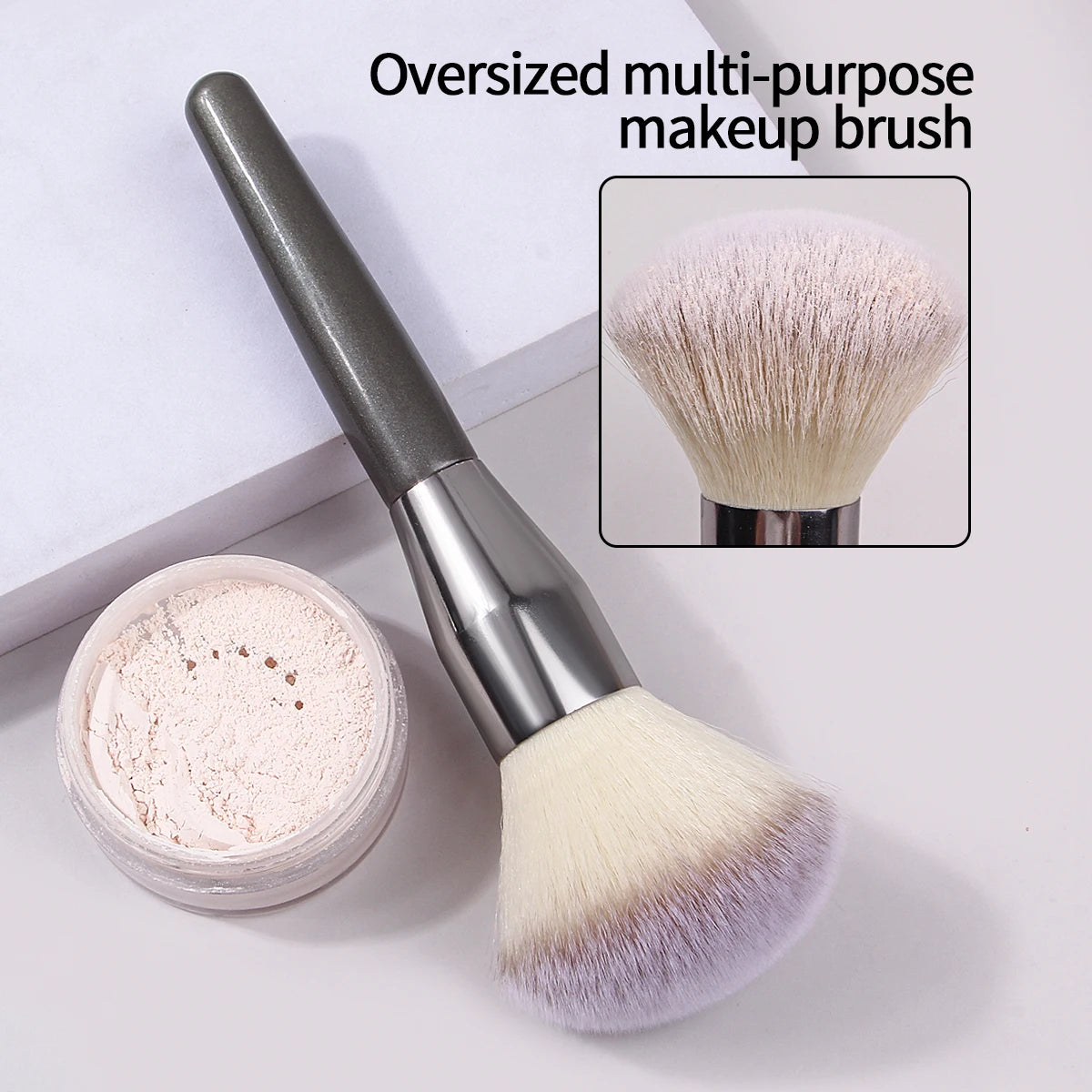 An oversized multi-purpose makeup brush with a silver handle and fluffy pink bristles is shown next to its powder.