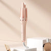 A pink professional automatic hair curling iron is shown standing on a white surface.