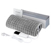 Gerolte graue Heizleitung mit Stromkabel und Adapter, verpackt in einer Box.