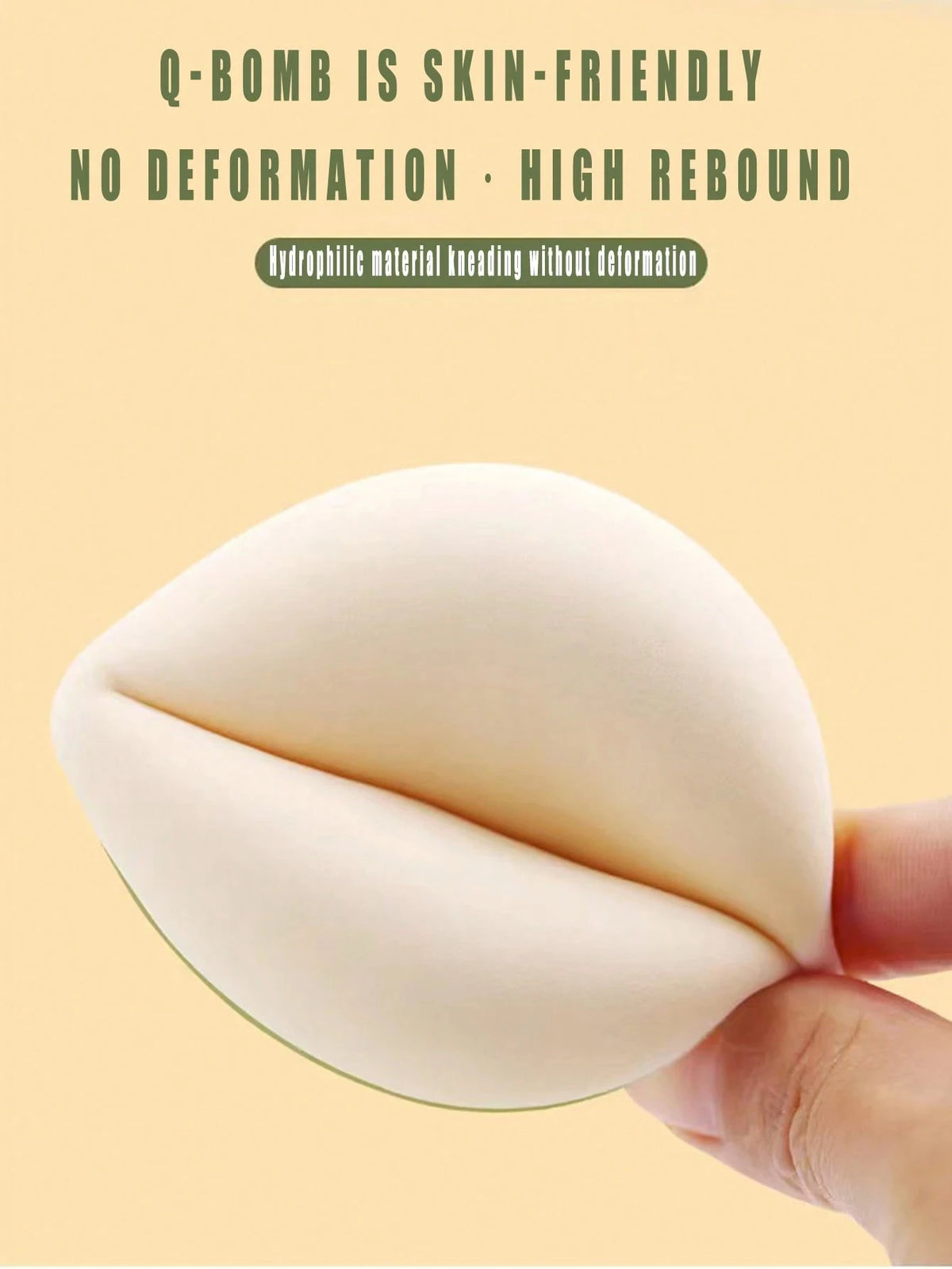 A close-up of a white makeup sponge puff being held by a hand, demonstrating its flexible and smooth texture.
