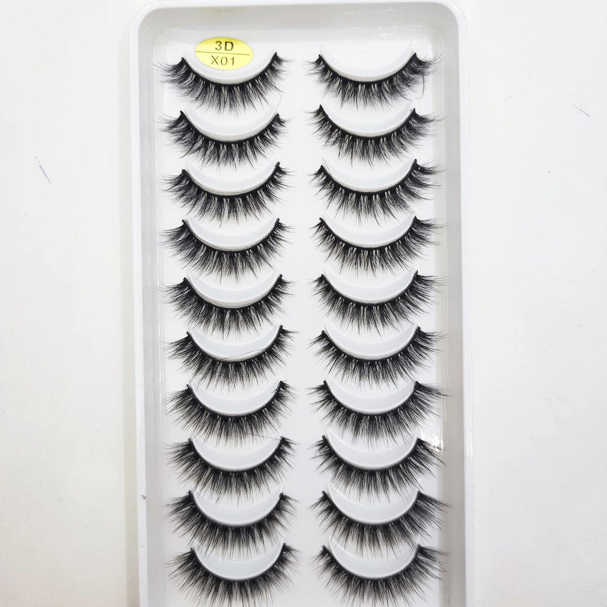A tray of natural 3D mink false eyelashes is displayed for sale.