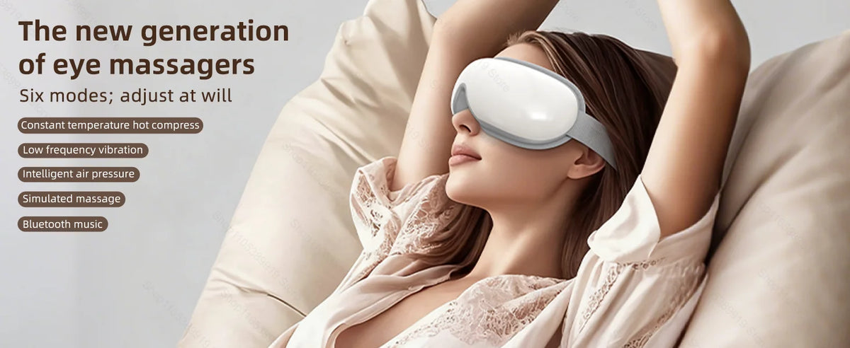 A woman is using a white eye massager device while relaxing on a couch.