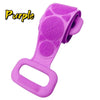 A purple silicone body scrubber and massager with a handle and textured silicone pads.