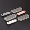 Three stainless steel foot files with plastic handles are displayed on a dark surface.