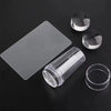 A transparent silicone nail art stamper set featuring a flat stamp and two round stamps on a dark surface.