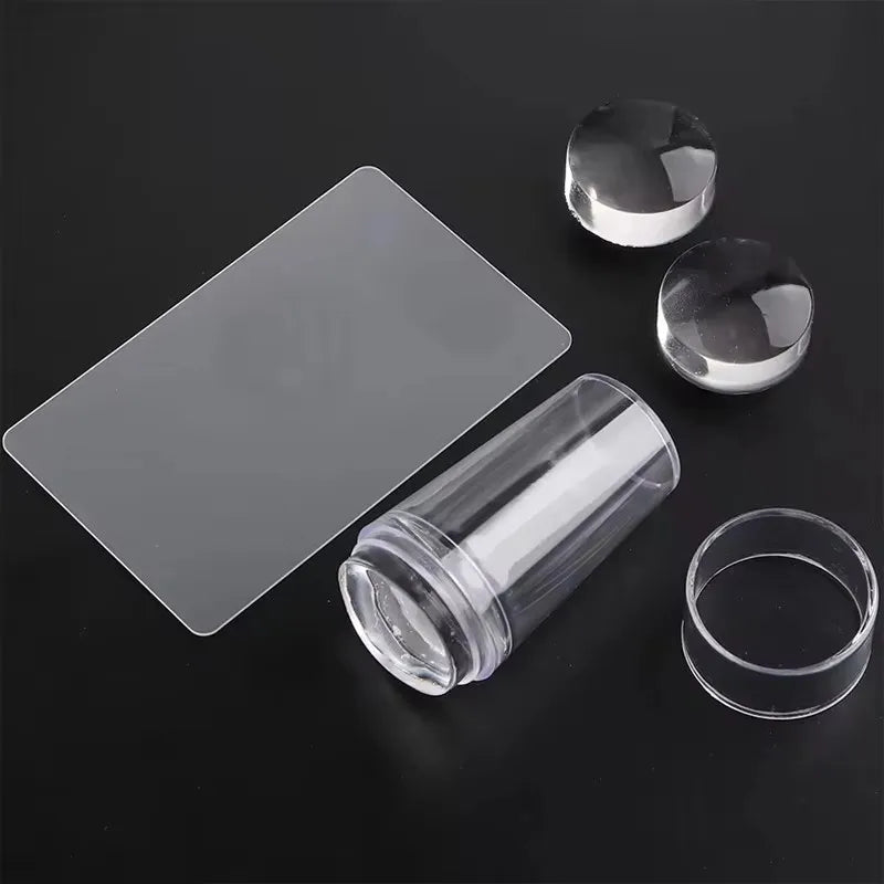A transparent silicone nail art stamper set featuring a flat stamp and two round stamps on a dark surface.