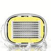 A silver precision manual safety razor with a yellow handle and a grid of blades is shown being splashed by water.