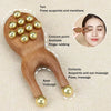 A natural wood facial and scalp massage comb with multiple points for acupoints and massage