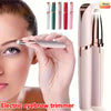 A hand is using a pink electric eyebrow trimmer to shape the eyebrows of a woman.