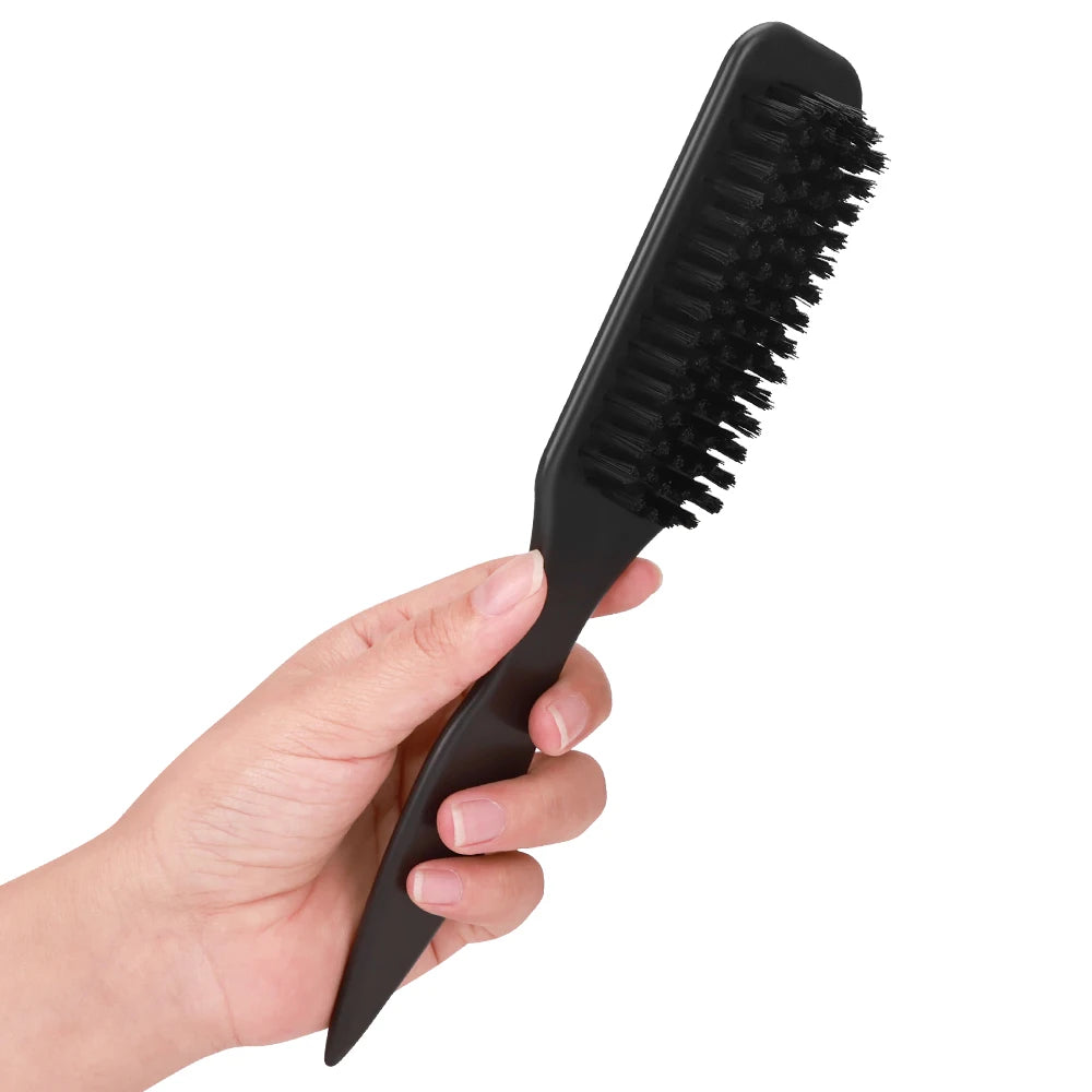 A hand holds a black boar bristle hair styling brush set with a metal tail comb.