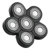 A black precision electric razor head with multiple rotating blades.