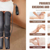 A pair of black air compression leg massager sleeves being worn on a person's legs.
