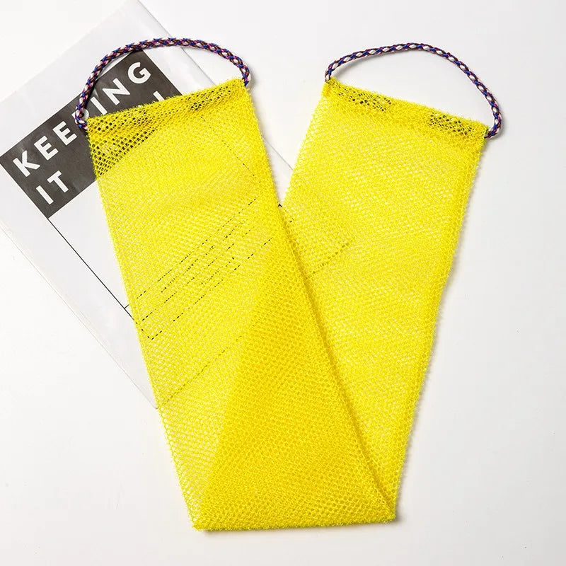 A bright yellow exfoliating sponge with purple string is shown against a white background.