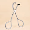 A pair of stainless steel wide-angle eyelash curlers with black tips displayed against a light background.
