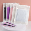 A collection of bulk eyelash extension cleaning swabs in various colors, packaged in clear plastic bags.