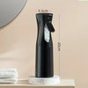 A black 200ml continuous fine mist spray bottle for hair and wigs is displayed on a light surface.