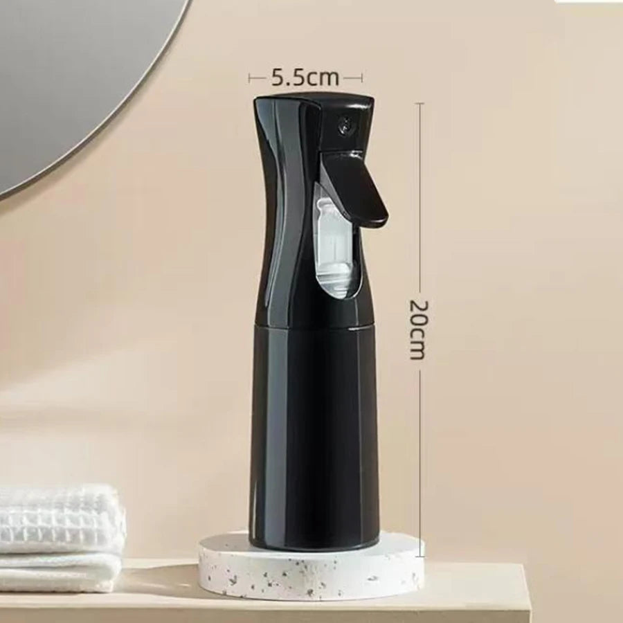 A black 200ml continuous fine mist spray bottle for hair and wigs is displayed on a light surface.