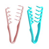 A pair of volumizing wide-tooth hair styling combs in pink and turquoise.