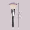 A silver face powder brush with a large, fluffy, purple-tinted synthetic hair and a long handle.