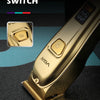 Close-up of a gold-colored electric hair clipper trimmer with an on/off switch visible.