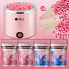A pink professional wax heater device next to various sizes of hard wax beans.