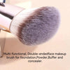 A close-up of a silver makeup brush with a dense, grey synthetic hair, used for foundation, powder, buffing, and concealer.