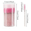 A clear container holding pink and black disposable eyelash and eyebrow makeup brushes.