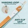 A wooden body exfoliating brush with a white grip and hanging loop for effective drying.