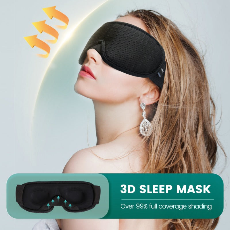 A woman is wearing a black 3D sleep mask with silver accents, demonstrating its full coverage shading.
