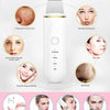 A white ultrasonic skin scrubber tool is shown with various benefits for the skin, including cleaning, lifting, and reducing 