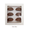 A white box containing three realistic silicone eyelash extension practice mannequin heads.