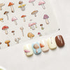 Watercolor mushroom nail art stickers arranged on a white surface.