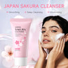 A pink tube of Japan Sakura Cleanser is shown next to a woman applying the foam to her face.