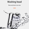 A close-up of a chrome mini electric beard trimmer shaver being rinsed and cleaned in one step.