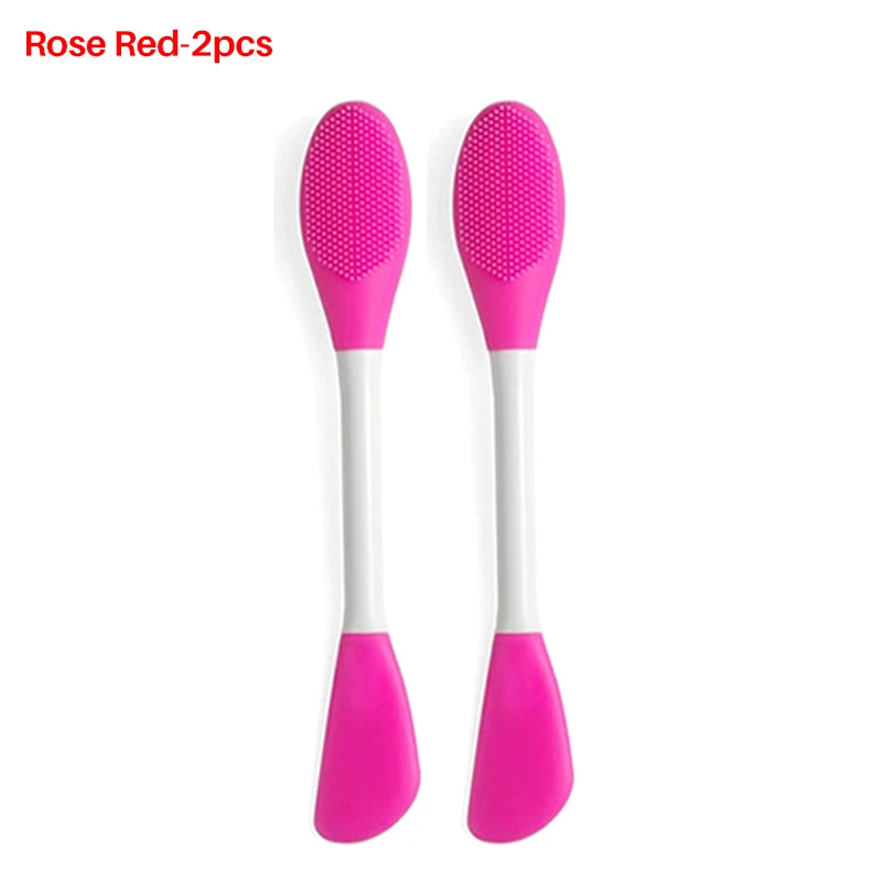 Two pink silicone facial mask applicators with white handles