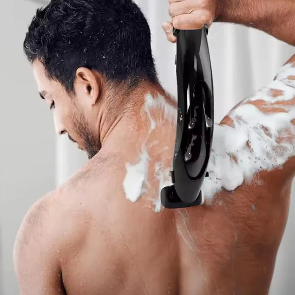 A man is using a black folding back shaver on his neck and shoulder.