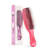 A pink Japanese-style scalp massage brush comb for hair styling and relaxation is shown in its box.