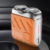 An orange and silver portable shaver with dual heads is shown on a dark surface.