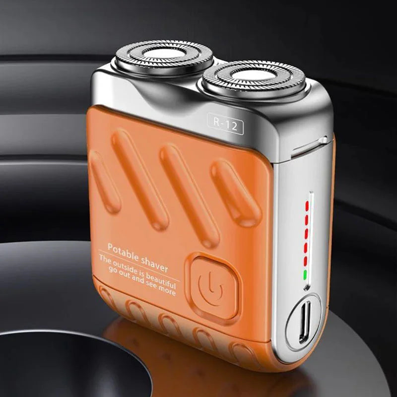 An orange and silver portable shaver with dual heads is shown on a dark surface.