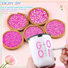 A kit for DIY crafting featuring various sizes of pink and purple rhinestones and a white mug with glitter writing