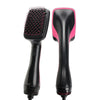 A black hot air brush hair styling tool with a pink handle and a black bristled head.